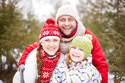 Happy family  with toothy smiles outdoors