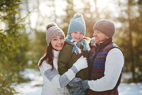 Portrait of happy family outdoors in winter