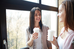 Friendly girls having coffee and talking