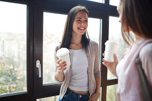 Two young specialists or students talking at coffee break