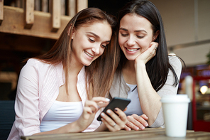 Friendly teenage girls reading messaging in social networks