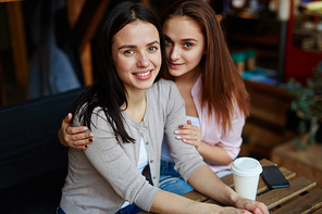 Friendly teenage girls relaxing in cafe