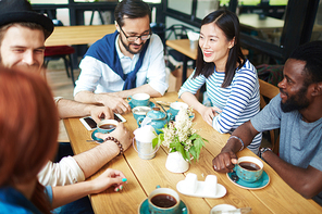 Get-together of young friends in outdoor cafe