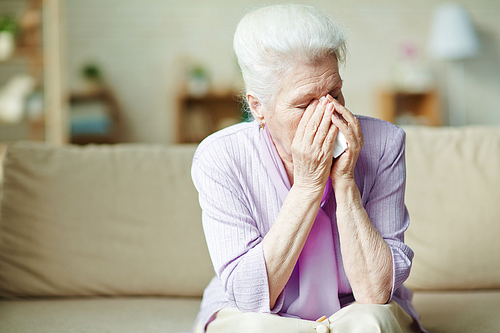 Unhappy senior woman crying