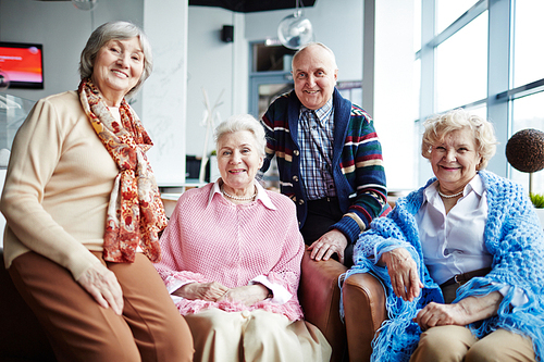 Group of happy seniors relaxing in cafe