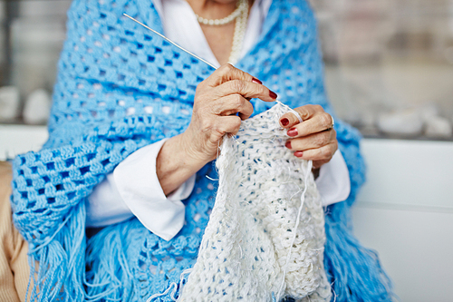 Elderly woman knitting at leisure