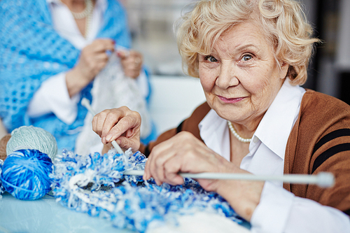 Elderly woman knitting and 