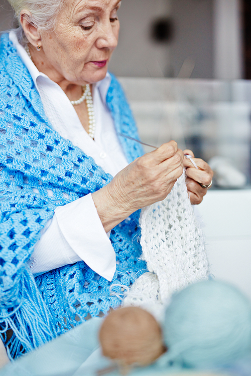 Granny knitting white woolen scarf