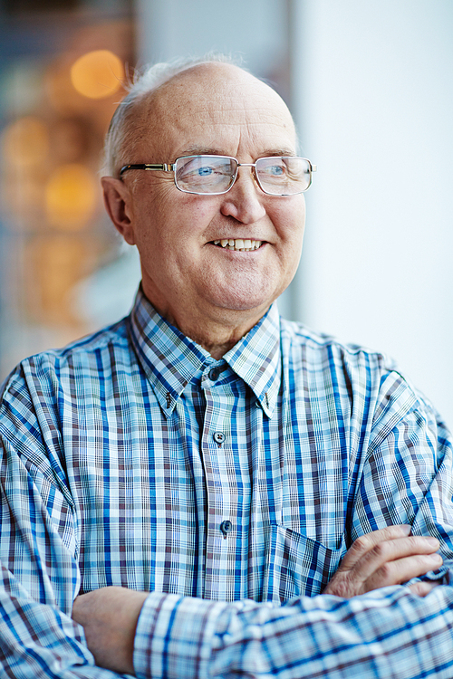 Happy senior man in eyeglasses and shirt