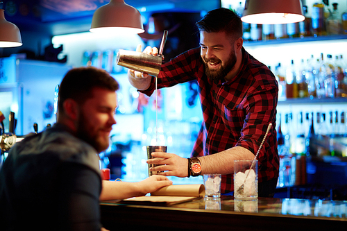 Happy barman making drink for guy