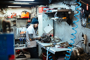 Modern repairman working in garage