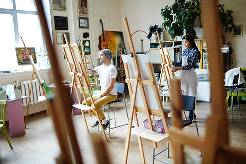 Young artists busy with painting at art studio