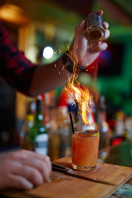 Close-up of bartender making hot cocktail at bar