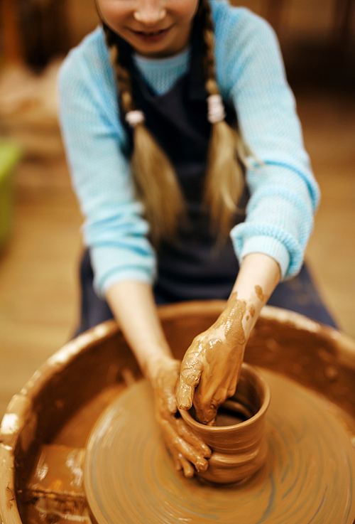 Schoolgirl learning how to make earthenware
