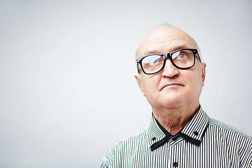 Portrait of senior in glasses looking up