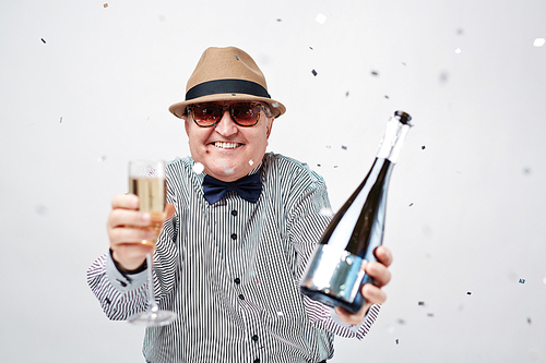 Happy senior man with champagne and flute