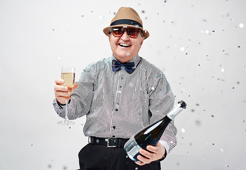 Laughing man toasting with champagne at party