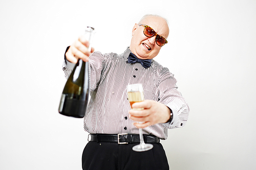 Cheerful senior man toasting with champagne