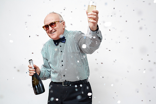 Happy senior man with bottle and flute of champagne  at party