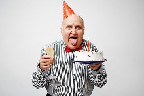 Ecstatic man with dessert and champagne celebrating his birthday
