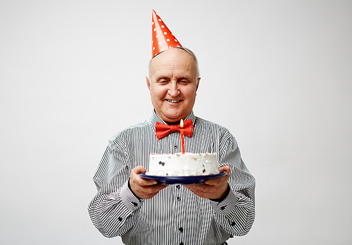 Happy elegant man holding birthday dessert