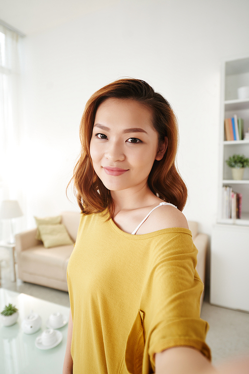 Lovely girl posing in front of camera in her room