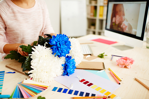 Woman florist making bunch for photo shoot