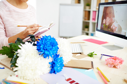 Graphic designer making notes in her notebook