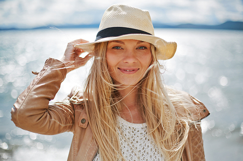 Cute girl in hat  by the seaside