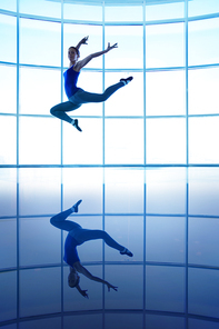 Young female dancer leaping in air