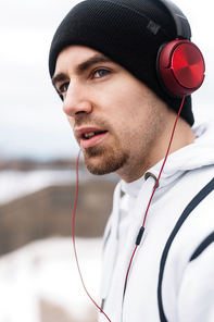 Sporty guy in headphones and activewear