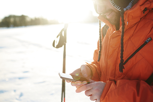 Skier messaging or reading sms in smartphone during training