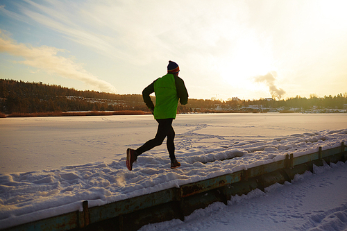 Athlete running in natural environment on winter morning