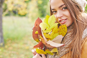 Pretty girl with yellow autumn leaves 