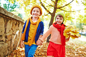 Two cute children enjoying walk in park