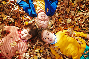 Cute children lying on autumn ground