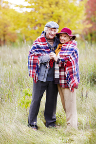 Old man and woman in warm clothes  in natural environment