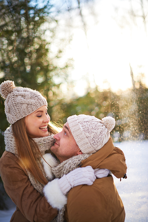Cheerful young couple enjoying winter day in park