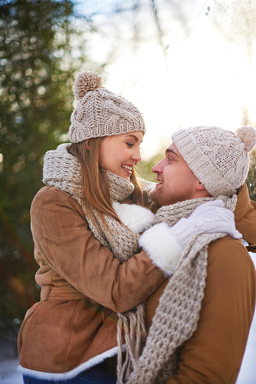 Lovely couple embracing outdoors in winter