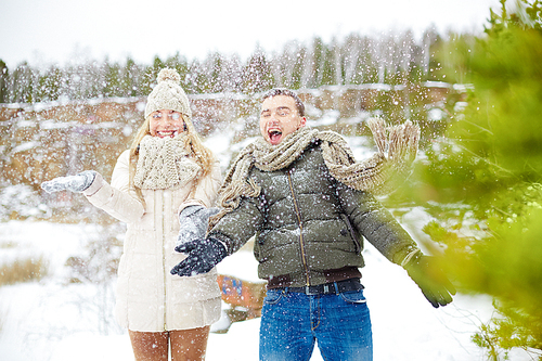 Ecstatic dates having fun in winter forest