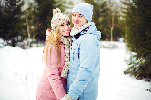 Young couple in winterwear having date in park