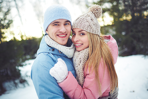 Happy couple embracing outdoors in winter