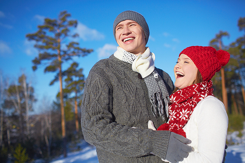 Joyful dates in knitted winterwear spending leisure outdoors
