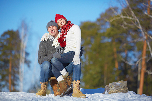 Affectionate couple spending leisure in winter park