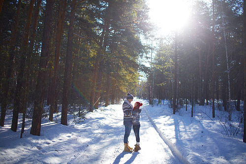 Amorous couple having romantic date in winter forest