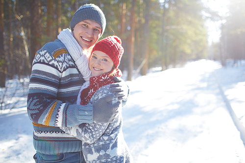 Amorous couple in casual winterwear  outdoors