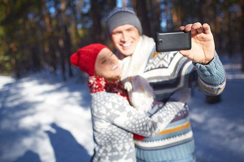 Amorous young couple making their selfie in natural environment