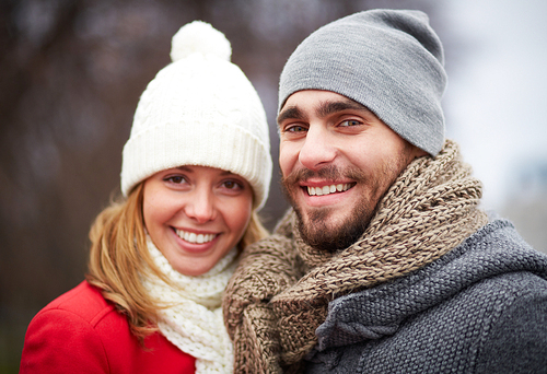 Happy guy and girl in warm clothes  outside