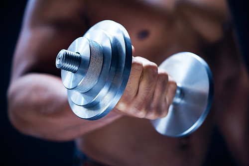 Close-up of male hand holding metal barbell