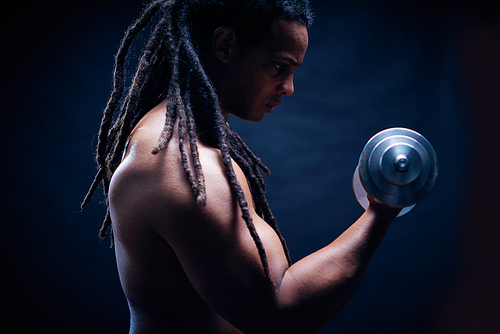 Portrait of bodybuilder training with dumbbells